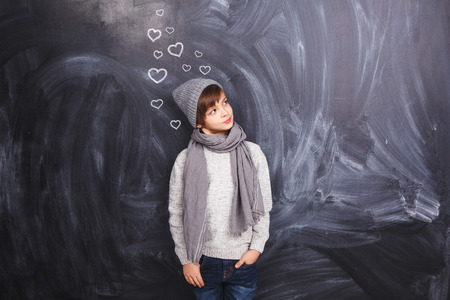 A boy on a gray background looking to the sideの写真素材