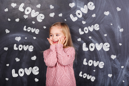 Little girl on a gray background with the words Loveの写真素材