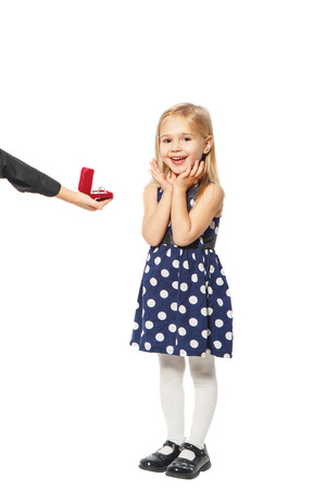 Girl takes a ring box that holds the hand of a boyの写真素材