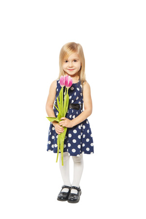 Girl in a dress on a white background holding a bouquet of flowersの写真素材