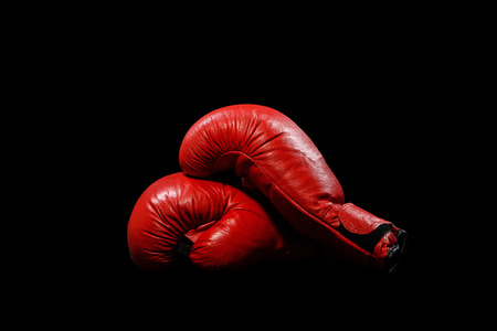 Two red gloves on a black backgroundの写真素材