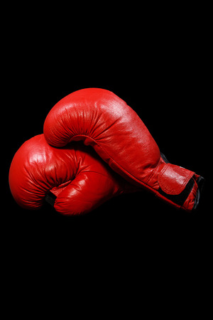 Two red gloves on a black backgroundの写真素材