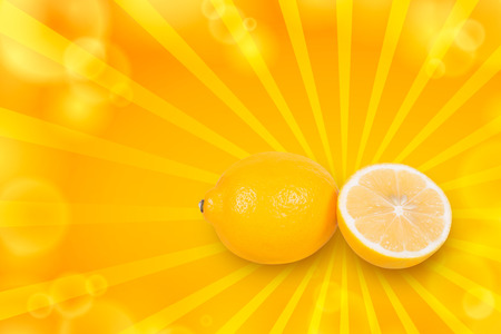 Cut lemon lies near a whole lemon on a white backgroundの写真素材