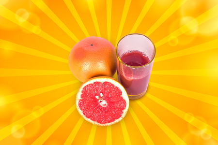 Juicy and ripe grapefruit near Frechet cup on a white backgroundの写真素材