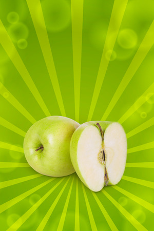 Green apple and half apple beside him on white backgroundの写真素材