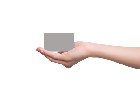 Business card lays on a female handの写真素材