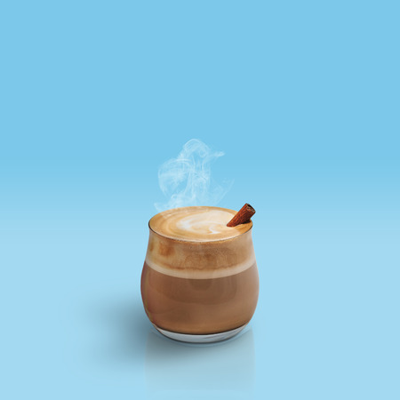 Cappuccino with cinnamon isolated on blue backgroundの写真素材