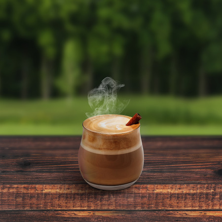 Cappuccino with cinnamon on wooden tableの写真素材