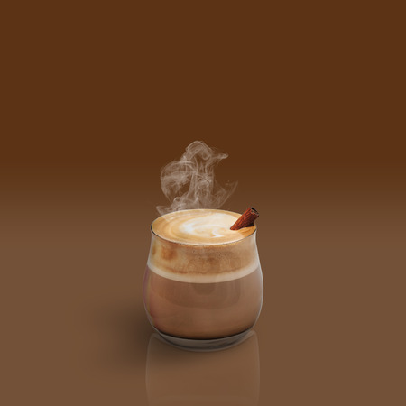 Cappuccino with cinnamon isolated on brown backgroundの写真素材