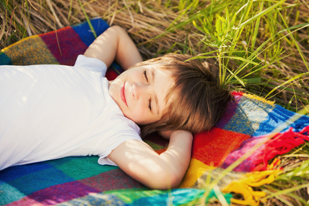 Little boy sleeping on natureの写真素材