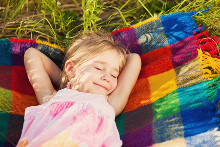 Little girl sleeping on natureの写真素材