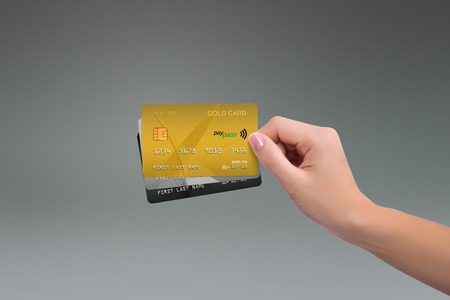 Isolated gold two more cards in woman handの写真素材