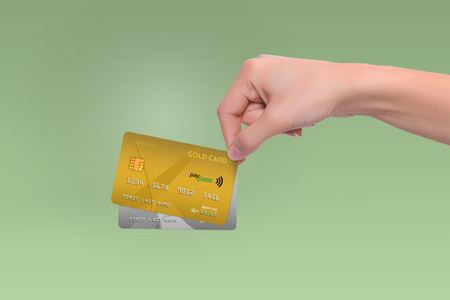 Isolated gold and gray credit cards in woman handの写真素材