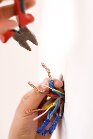 An electrician binding copper wires together and sealing them with insulation stripe.の写真素材