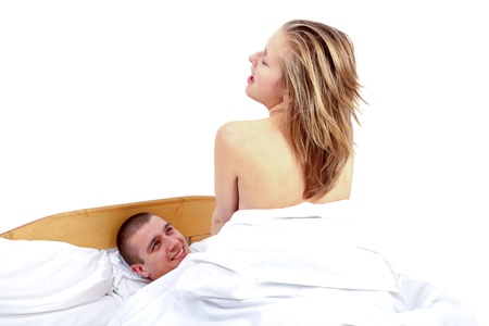 Young couple having sex in bed - woman on topの写真素材