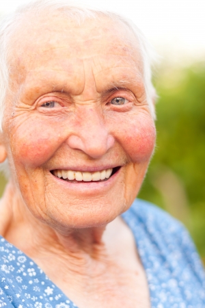 Elderly woman with blue eyes having toothy smile.の写真素材