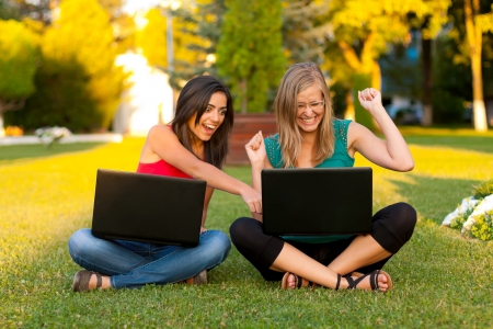 Young students looking at the laptop and expressing their surprise of good news.の写真素材