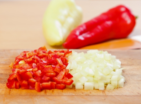 Paprika cut to pieces, whole peppers in the background.の写真素材