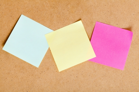 Sticky notes in natural light on a wooden board.の写真素材