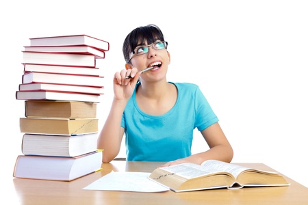 Good looking student with her face lifted towards copyspace having an idea and thinking about it - isolated on white.の写真素材