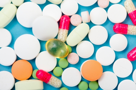 Various drugs, nutrient supplements and vitamins on blue background.の写真素材