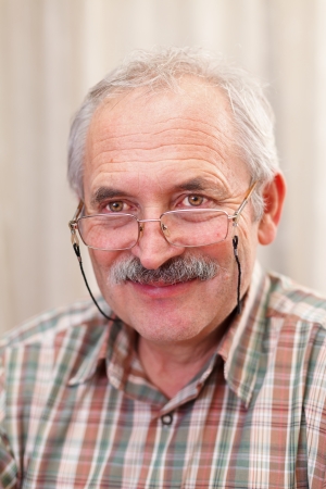 Portrait of a smiling senior man with glasses.の写真素材