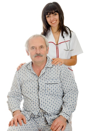 Young doctor/nurse smiling kindly standing behind a senior patient.の写真素材