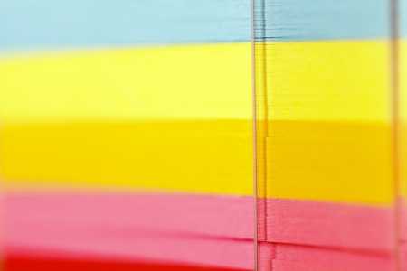 Closeup view of a block of colorful postits.