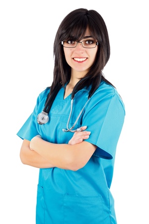 Kind brunette female doctor/nurse with stethoscope and arms folded smiling isolated on white.の写真素材