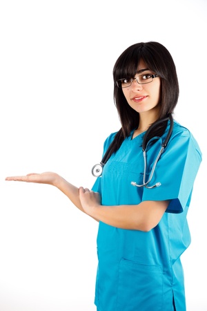 Beautiful brunette doctor holding or showing medical product isolated on white.の写真素材