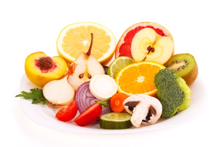 Mixed fresh fruits and vegetables half cut on a plate - isolated on white.の写真素材
