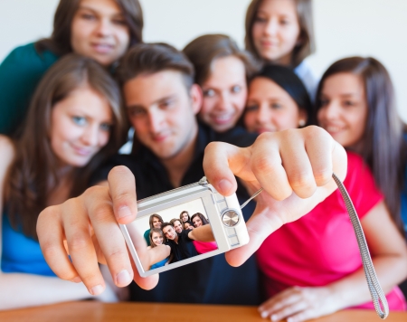 Young people taking picture of themselves with camera - selfpic series.の写真素材