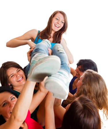 Team celebrating winner girl picked up in the air.の写真素材