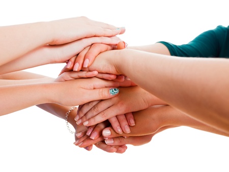 People's hands together symbolising unity in team. 