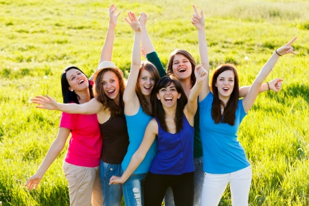 Lot of happy women cheering together outdoors.の写真素材