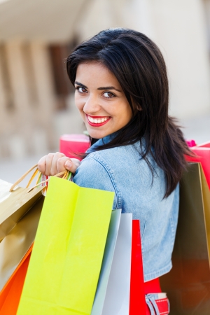 Gorgeous young lady holding shopping bags and smiling.の写真素材