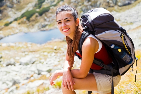 Young hiker woman with backpack on a mountain.の写真素材