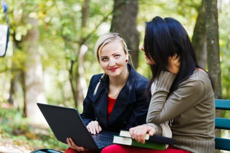 Girl friends outdoors preparing studying for the final examination. の写真素材