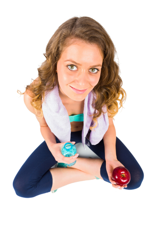 Smiley sporty woman doing fitness over white isolated background.の写真素材
