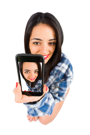 Young beautiful brunette lady taking selfies.の写真素材