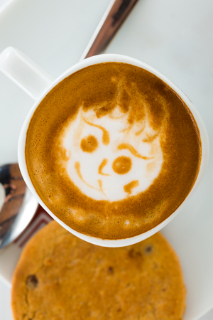 Coffee art on mug drawing on top of the liquid.の写真素材