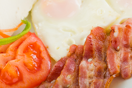 Delicious fried sunny-side up with vegetables and bacon.の写真素材
