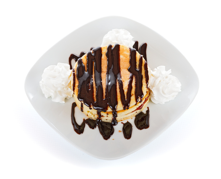 American pancakes with blueberry jam, chocolate topping and whipped cream.の写真素材