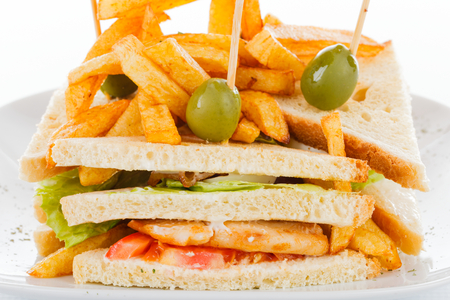 Tasty fresh sandwiches made of vegetables, chicken and bacon with chips isolated on white.の写真素材