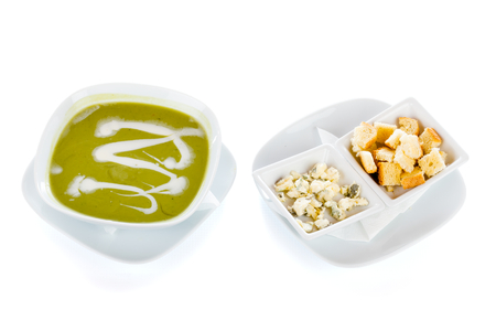 Extremely delicious broccoli creme soup with sour-creme, blue moldy cheese and toasted bread croutons.の写真素材