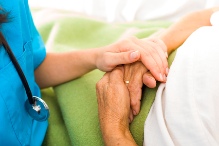 Care help love and trust to elderly people - holding hands.の写真素材