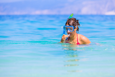 Brunette girl before getting underwater with her snorkeling gear.の写真素材
