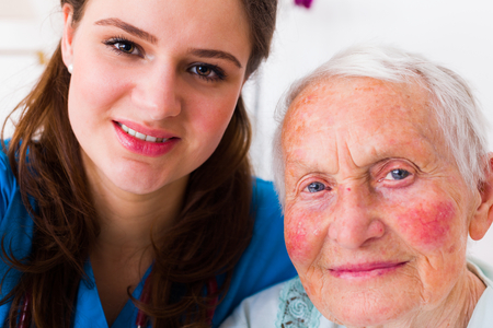 Beautiful doctor with a beautiful senior patient taking a selfie to send news to relatives from the hospital.の写真素材