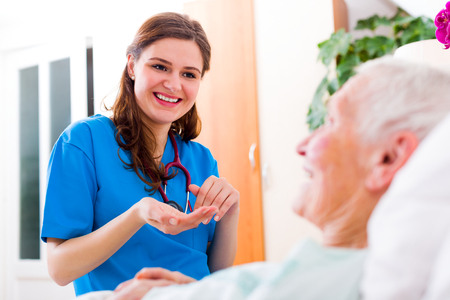 Geriatric doctor listening to the elderly woman patient with attention and care.の写真素材