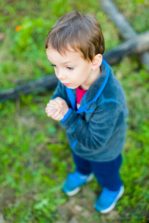 Faithful little boy praying to God in hope that he will listen to him.の写真素材